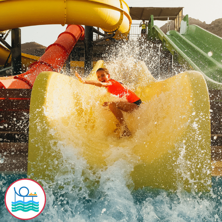 Child surfing on the waterslide in a water park