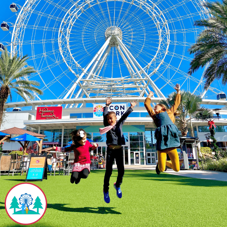 children jumping and happy in front a theme park