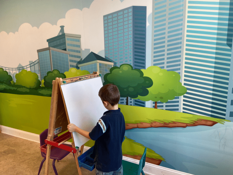 Lewisburg Children’s Museum art exhibit with little boy painting