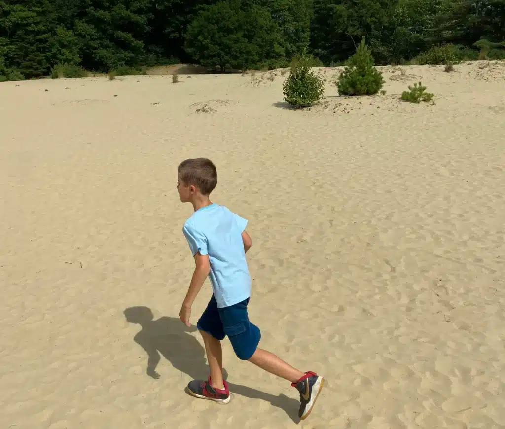 child running in the desert of maine park