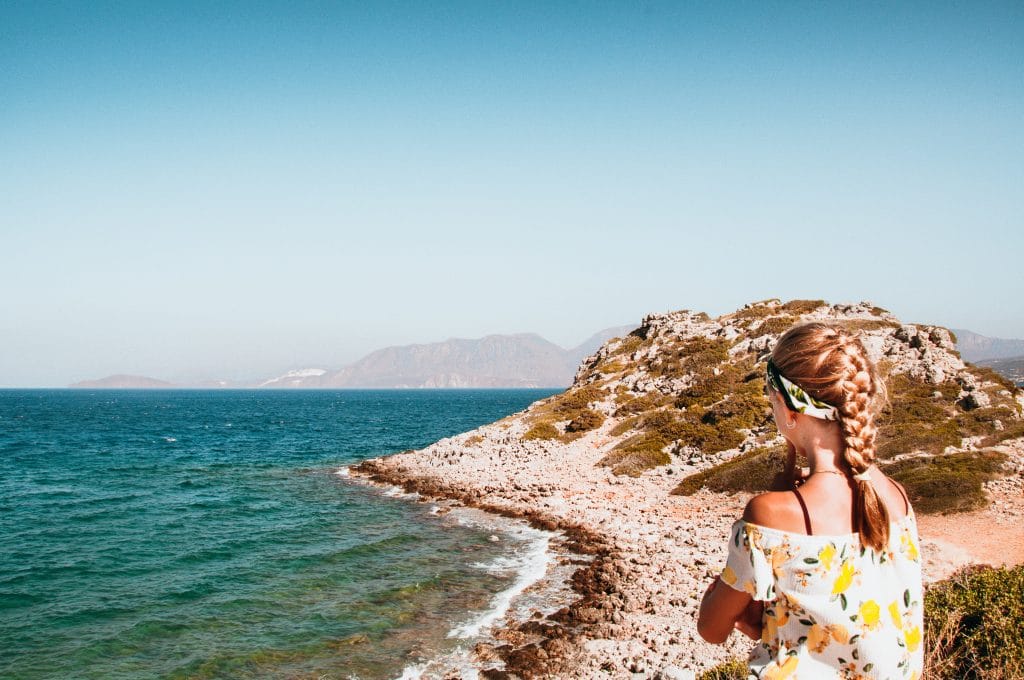 Girl watching the sea in Crete, Greece.