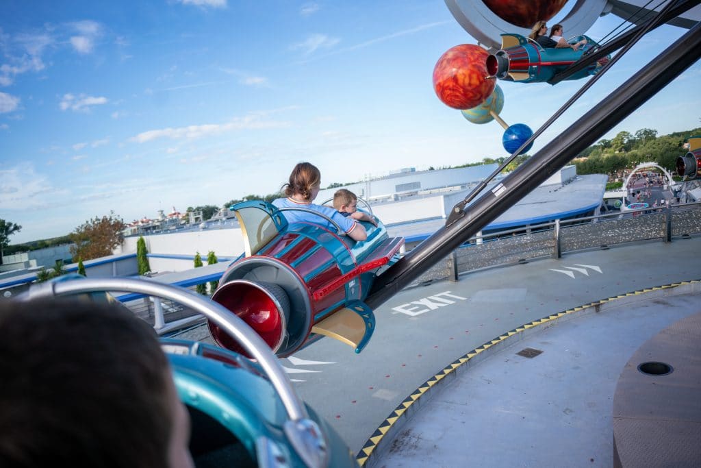 Child and Parent in an attraction at Disney World.