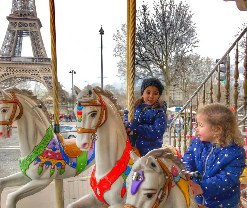 Kids in front of the eiffel tower in carrousel
