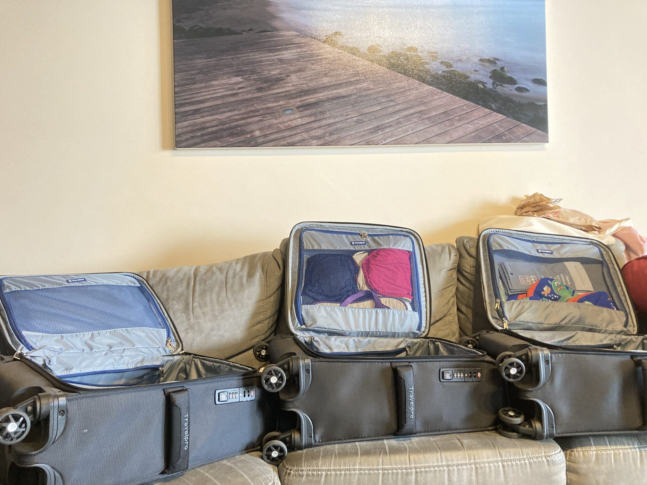 Three carry on luggages. minimalist family travel blog cover