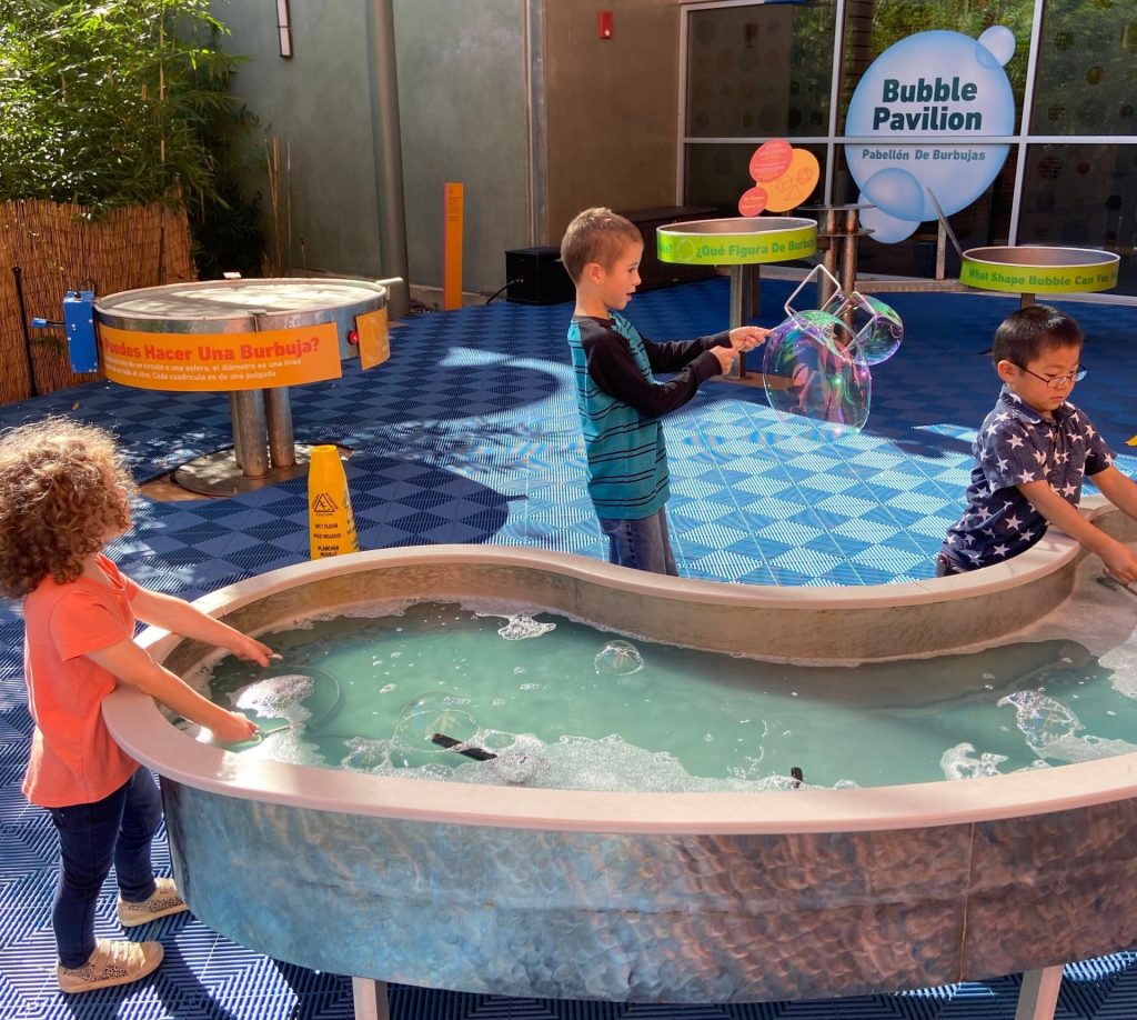 Children playin with the water display at the doseum