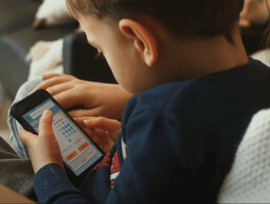 Little boy using the Gowhee App on a phone