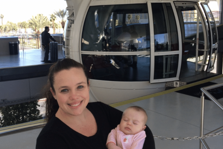A mom and child waiting at the high roller wheel