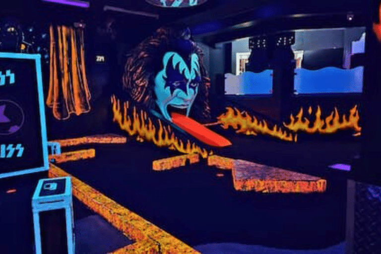 Inside the KISS minigolf with a glowing face of the singer pulling his tong out