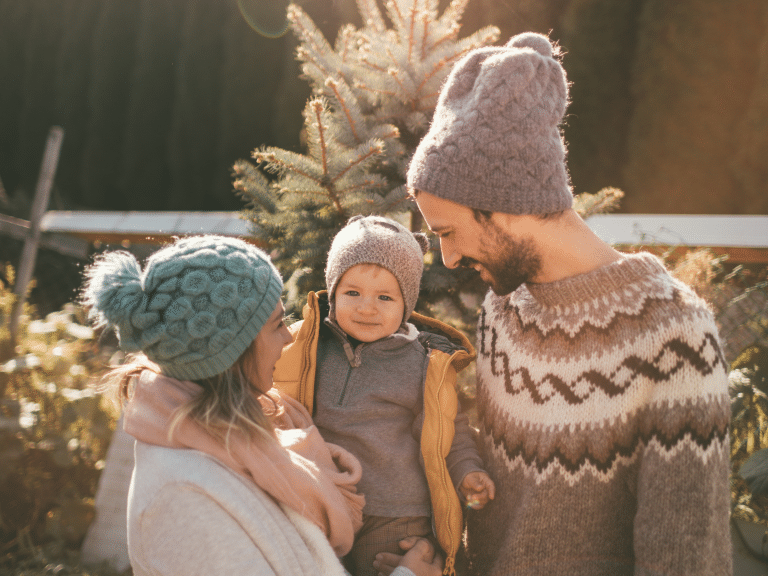 Parents and child enjoying their cheap family vacations with sweater and hats