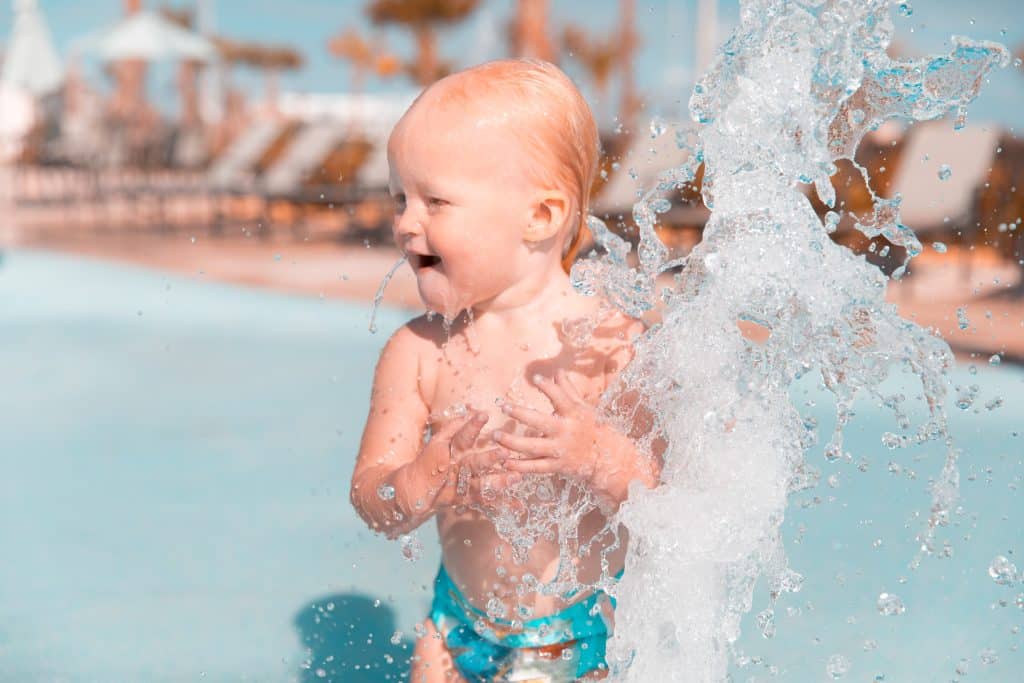 Baby enjoying one of the best cruise lines for families at the pool