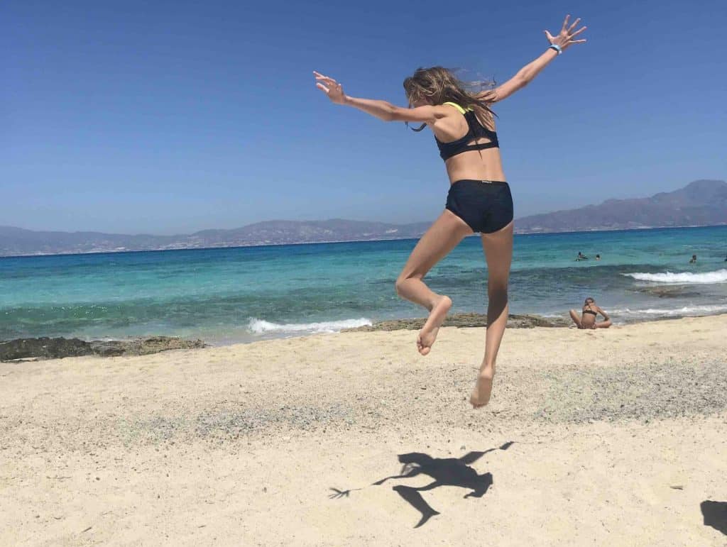 Little girl jumping on a beach