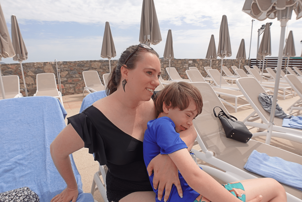 Mom and child enjoying an all inclusive resort by the pool