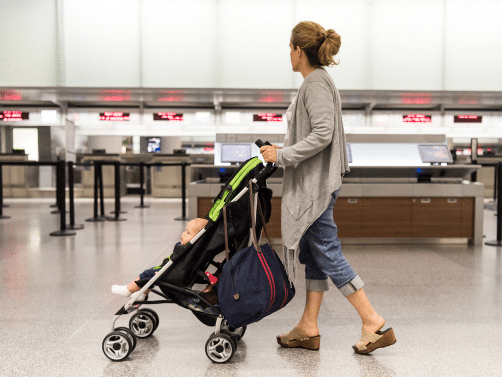 Mother pushing a stroller in an airport